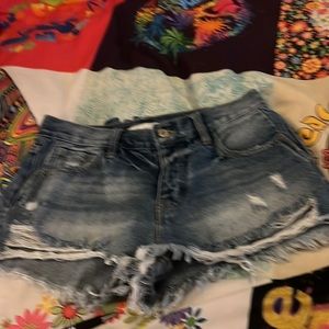 Distressed, blue Jean shorts. Slightly used.